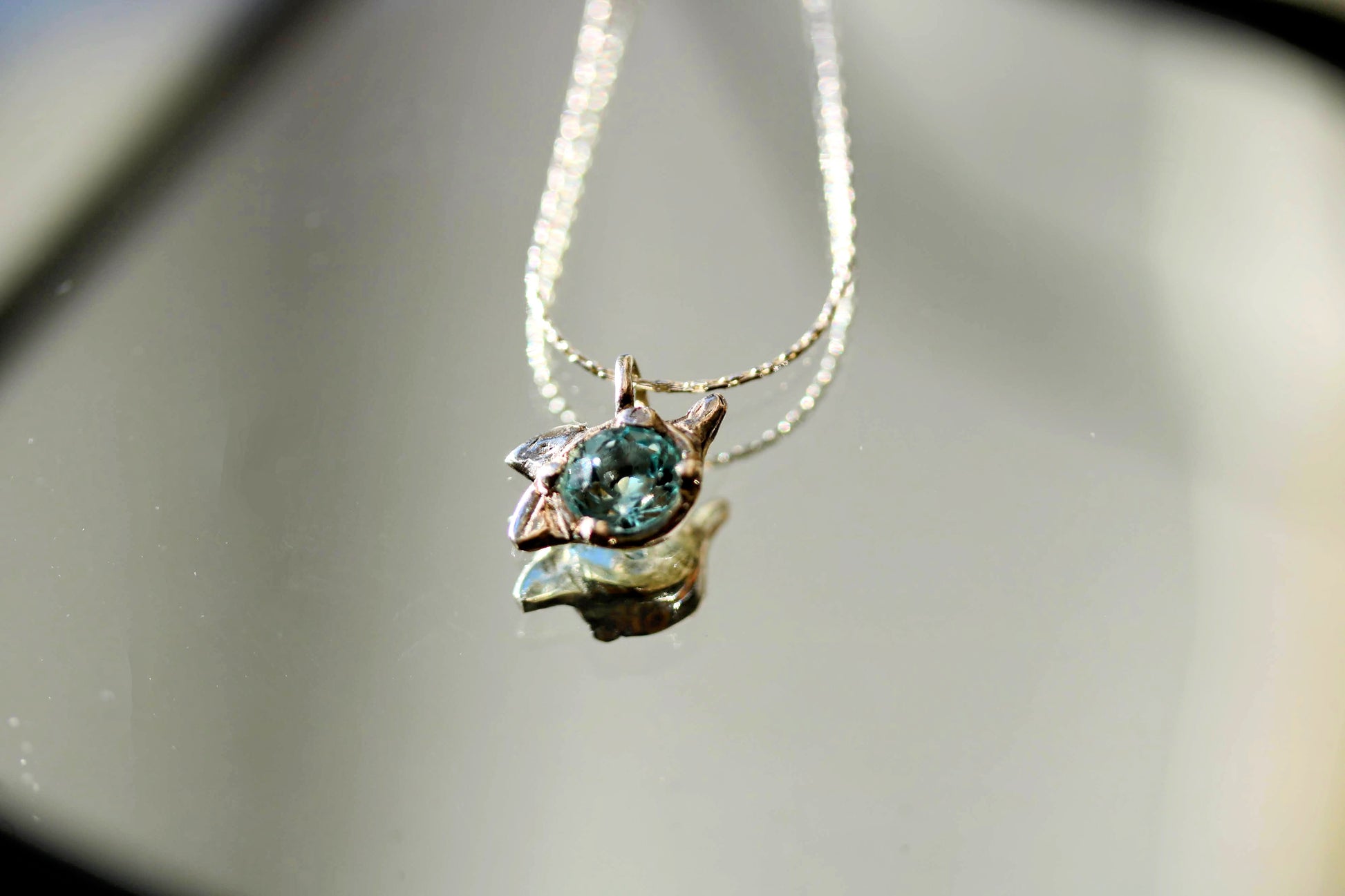 silver necklace with blue topaz