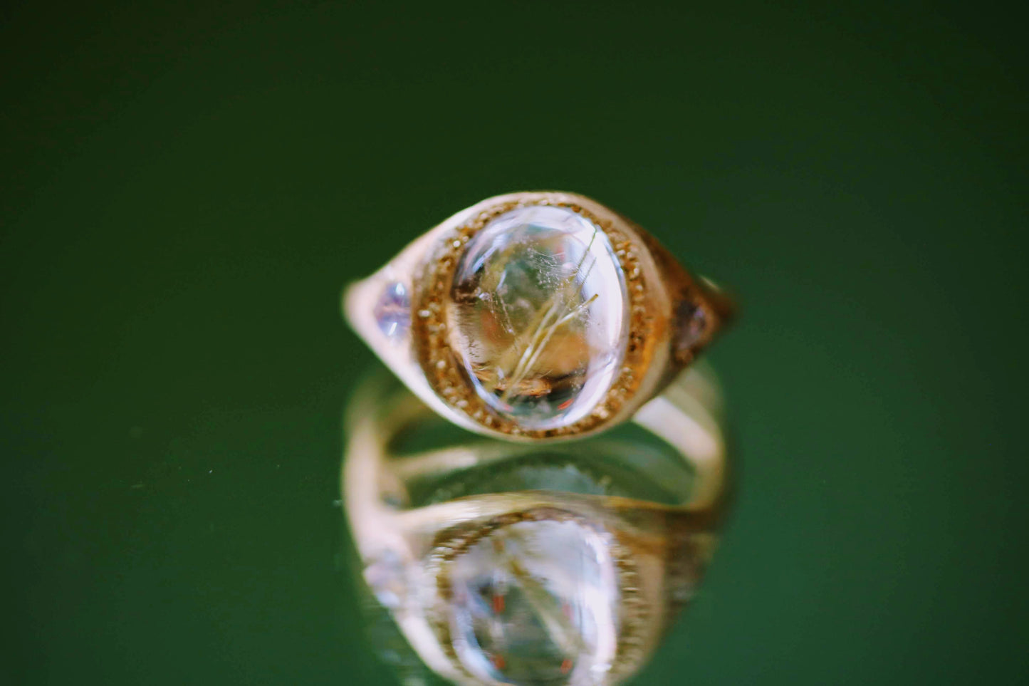 gold rutile quartz ring with blue moonstones